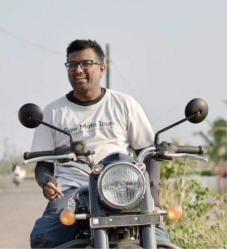 Pratish, co-founder of Slow Moto Tours, on a Royal Enfield in Kerala
